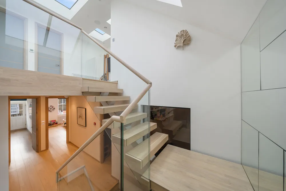 Floating oak staircase with glass balustrade