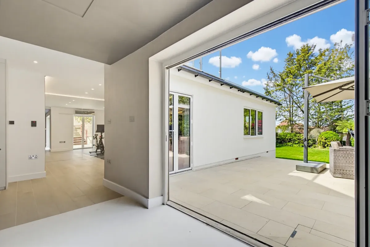 Rear extension opening onto the garden through full-height sliding doors in Hampstead